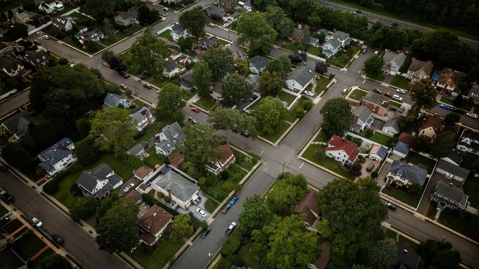 Aerial view of a tree-lined neighborhood of single-family homes