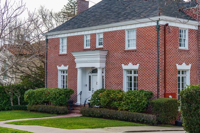 Red-brick colonial home with a white portico