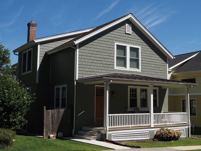 Two-story shingle house with a white front porch